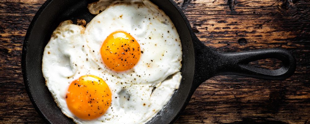 fried eggs in black pan