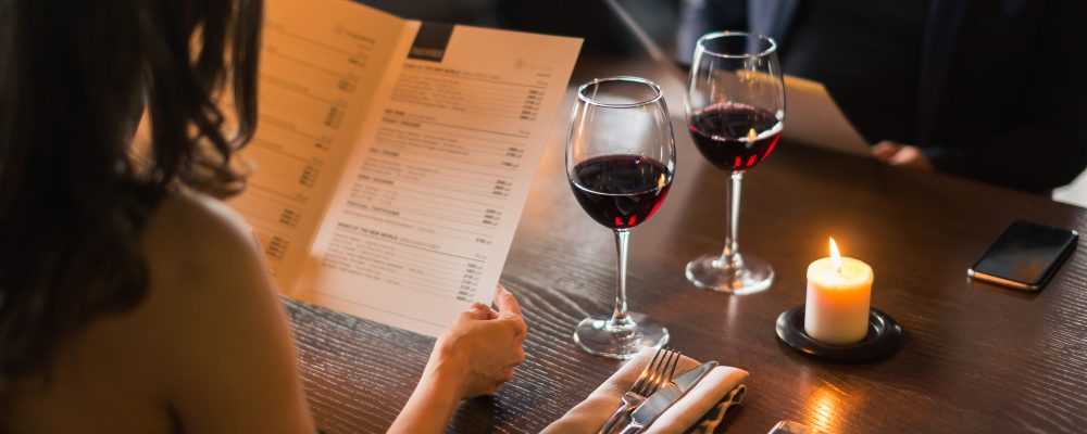 Cheerful couple with menu in a restaurant making order