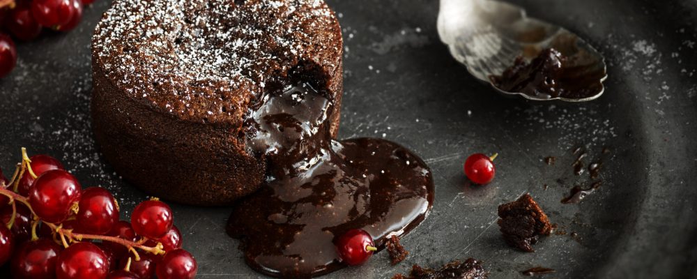 Chocolate Lava Cake with Gooey Molten Center Pouring on to Plate