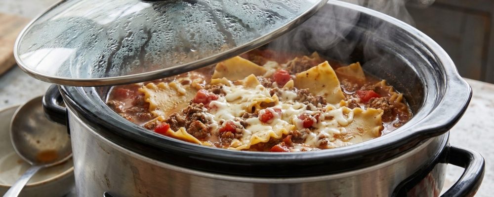 Homemade Cheesy Lasagna Cooking in a Slow Cooker with Steam Rising. Delicious, Hot Comfort Food for Easy Family Meals and Weeknight Dinners.