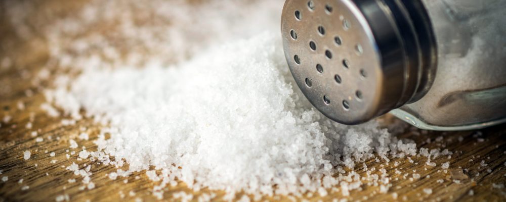 Salt on wooden background
