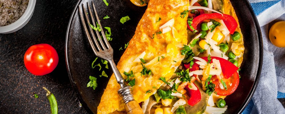 Healthy breakfast food, Stuffed egg omelette with vegetable, dark concrete background copy space top view
