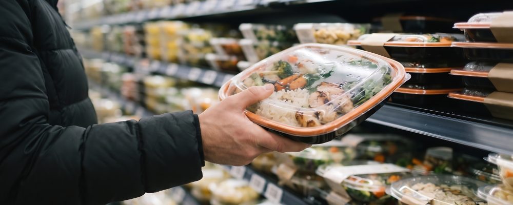 Buying healthy ready meals. Supermarket aisle shopping. Food packaging display. Convenient dinner choice.