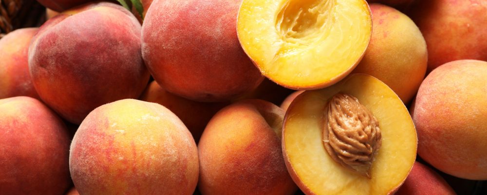 Fresh sweet ripe peaches as background