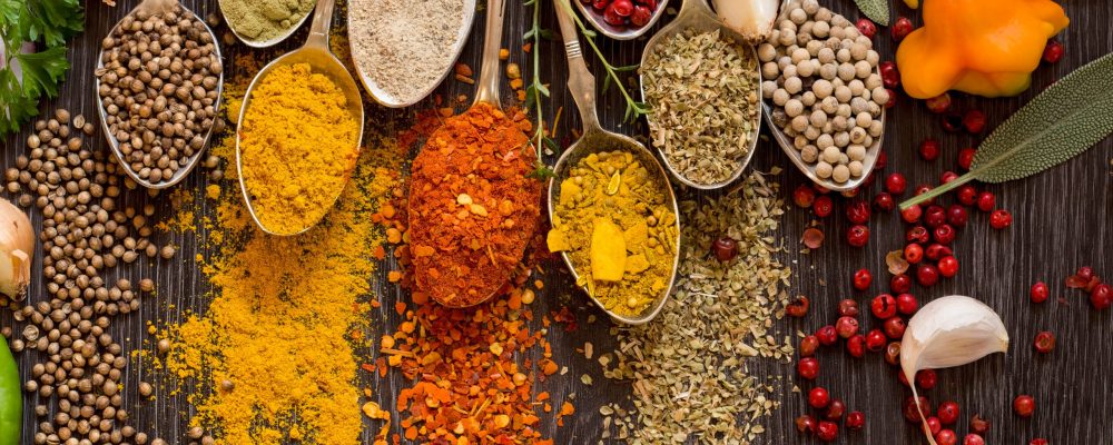 Various herbs and spices in vintage spoons