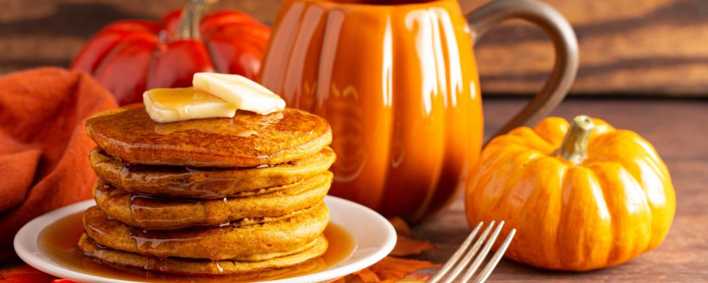 A Stack of Pumpkin Spice Flavored Pancakes on a Wooden Table