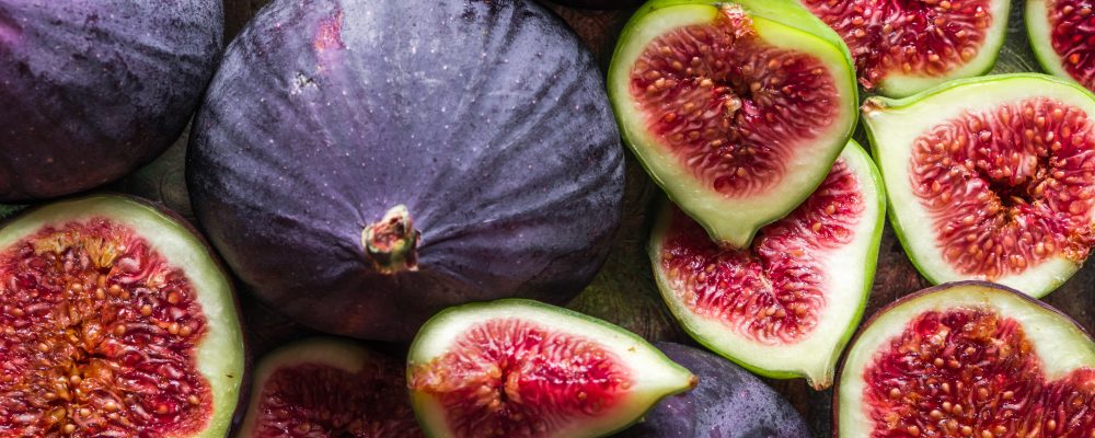 Background of figs. Fresh, juicy ripe fig fruits slices.