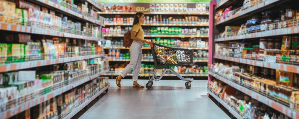 woman with shopping between store shelf copy space