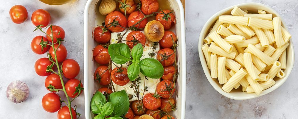 Trending viral Feta baked pasta recipe made of cherry tomatoes, feta cheese, garlic, and herbs in a casserole dish. Great sauce for rigatoni or penne.