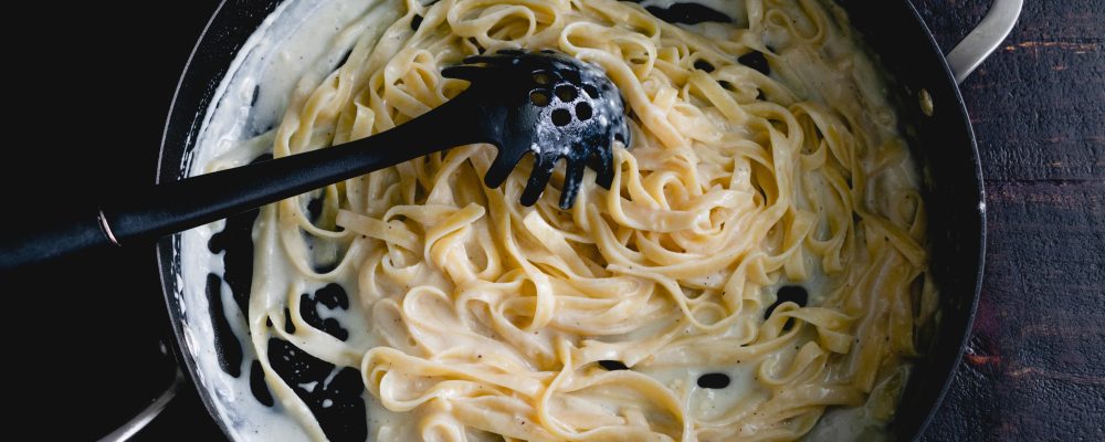 Fettuccine Alfredo in a Saute Pan: Freshly made noodles in a creamy parmesan cheese sauce