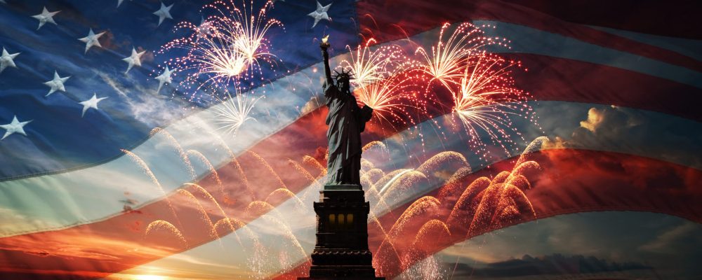 Statue of Liberty on the background of flag usa, sunrise and fireworks