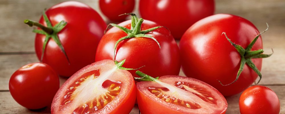 Fresh red tomatoes on wooden table