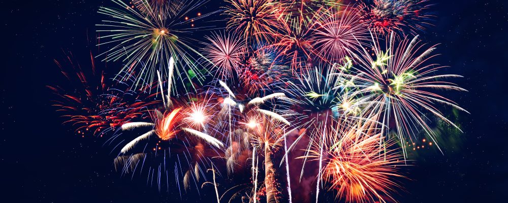 Fireworks at night over dark blue sky