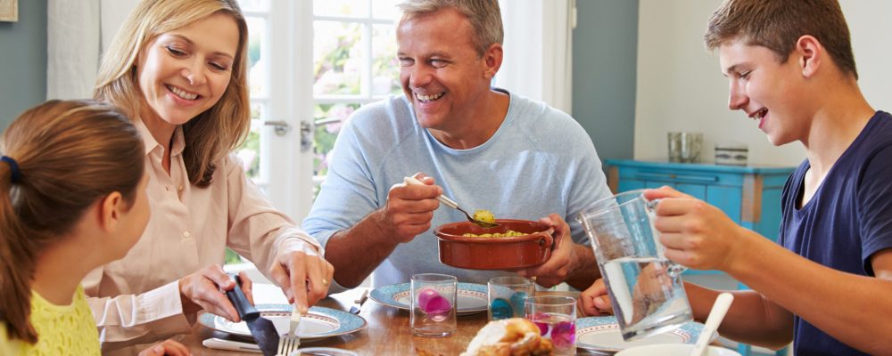 Family Enjoying Meal At Home Together