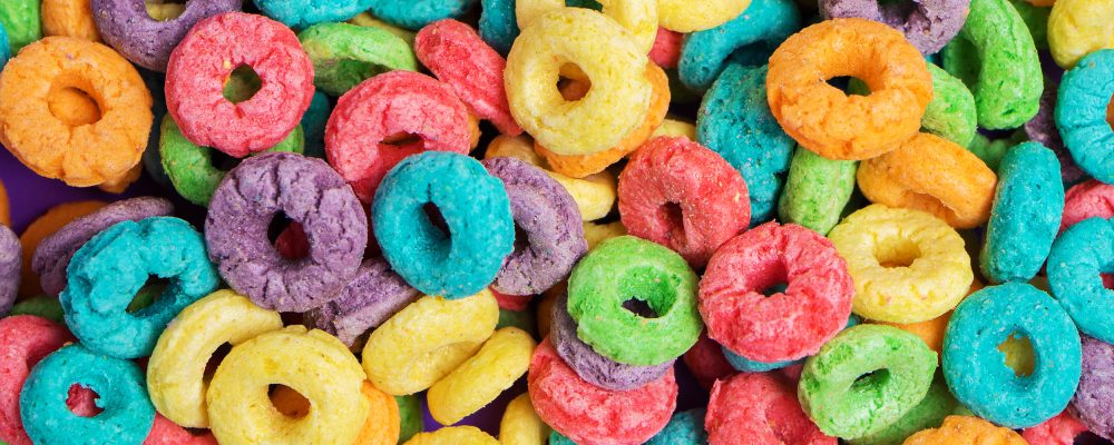background. Colorful cereal  on a purple background